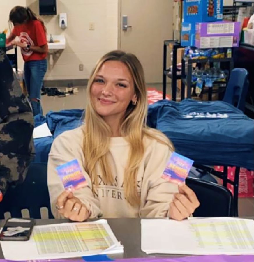 Lizzy Prather handing out senior sunrise tickets in the cafeteria Sept. 30.  Tickets were free and the breakfast was sponsored by Student Council.