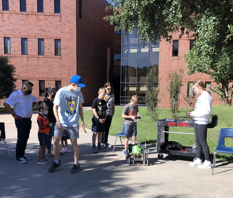 Stone Meng (12) and Daniela Llaguno (11) are in the courtyard at TWHS.  They demonstrated one of the TWHS robotics robots.