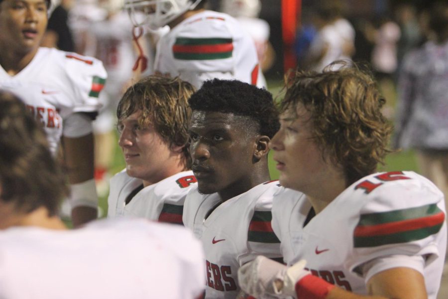 Junior Ryder Brady (l) and senior Andrew Larkworthy (r) flank senior Martrell Harris on the bench against Oak Ridge Oct 15. at Woodforest Bank Stadium.