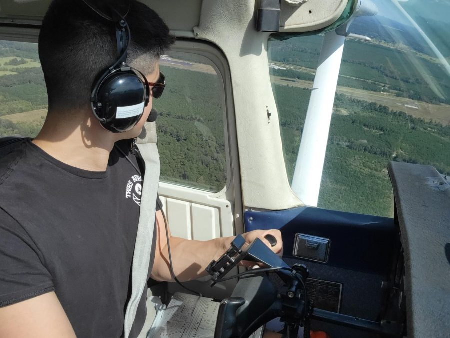 Javier Pena in his plane as he approaches Woodforest Stadium on Friday, Oct. 22.