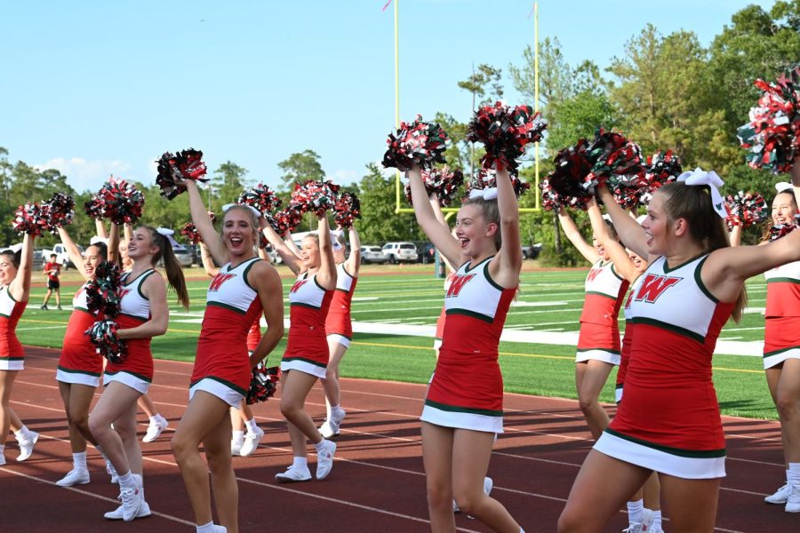 Varsity cheer took the field when the varsity football squad walked through some plays during Meet the Player at Willig field.
