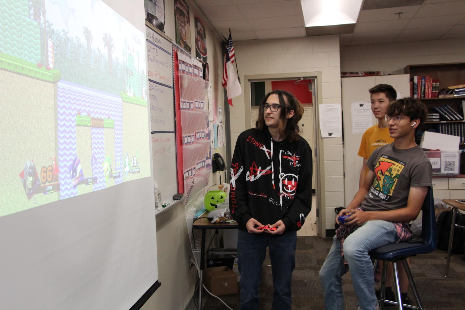 From left, Brian Bostad, Kevin Smith and Max Basurto play Super Smash Bros. in room 241 on Sept. 20.