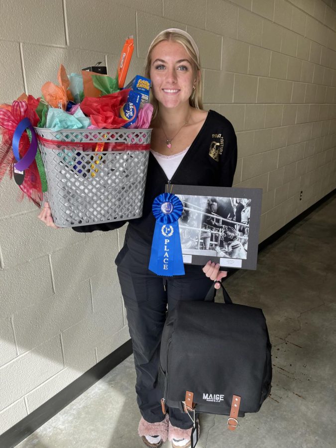 Best in show MJ Monroe and her swag - a camera bag and a crate full of tasty treats.  Monroe is a student in Mrs. Pelosis Photo 2 class.