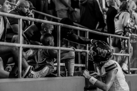 MJ Monroes winning photo in the Open category.  Junior quarterback Mabrey Mettauer in the stands after a tough loss in the first game of the season against Northshore.