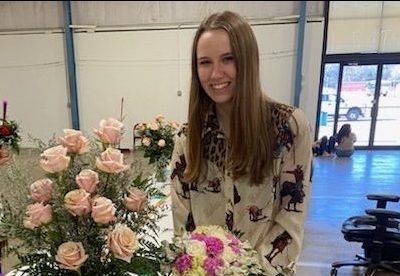 Reagan Weaver, with three of the bouquets she created as part of the competition.