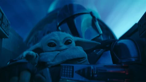 Grogu (l) and Din Djarin (r)  (Pedro Pascal) in the cockpit in The Mandalorian, on Disney+.