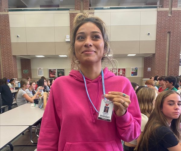 Freshman Paxton Harmon and her badge in the cafeteria this week.