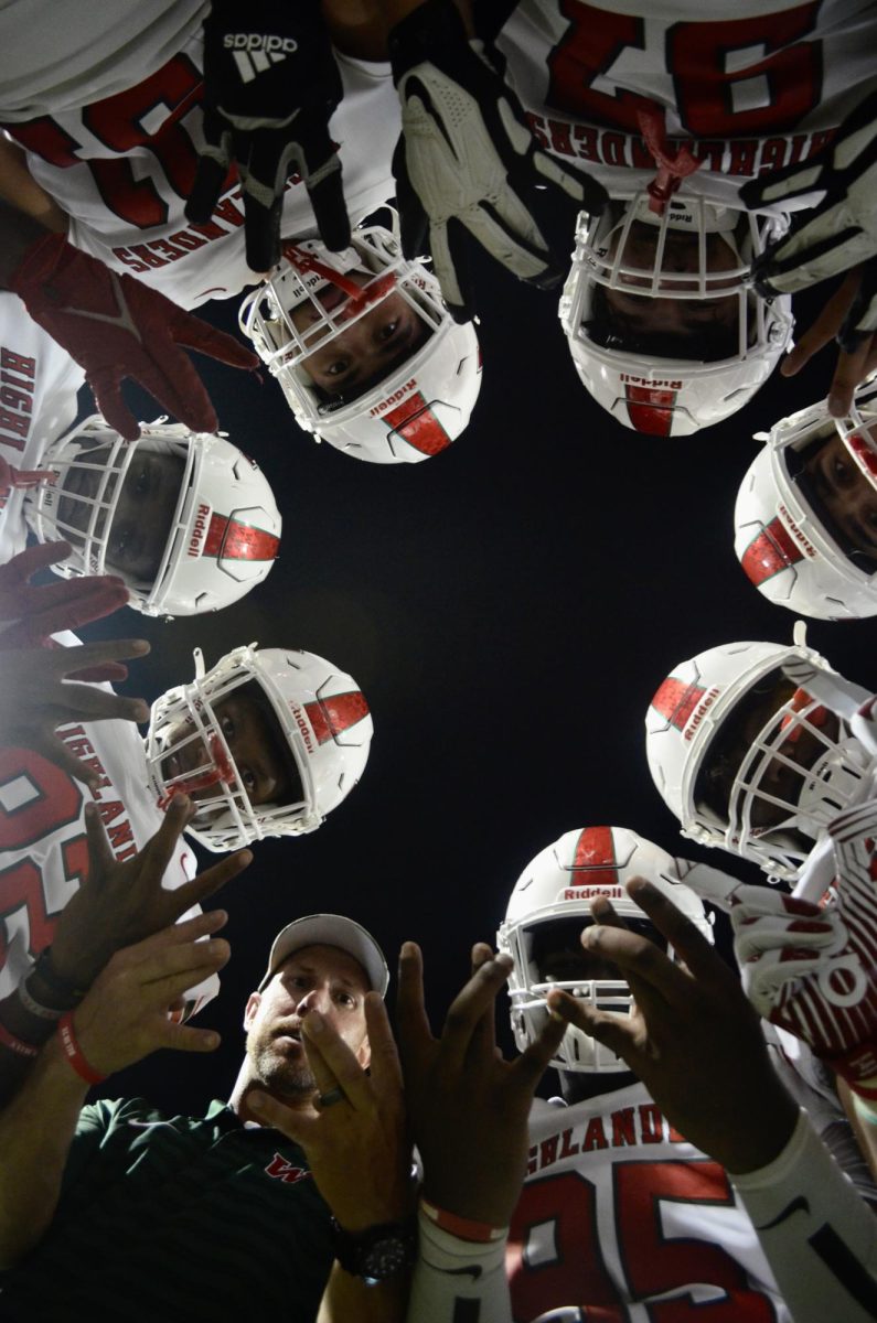 The Highlanders in a huddle with Coach Nash. 