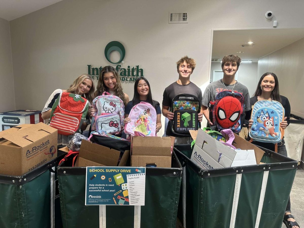 Ava Torres, Reese Kim, Siena Kayo, Aiden Hicks and Aiden Dore showcasing backpacks to be given for donations. 