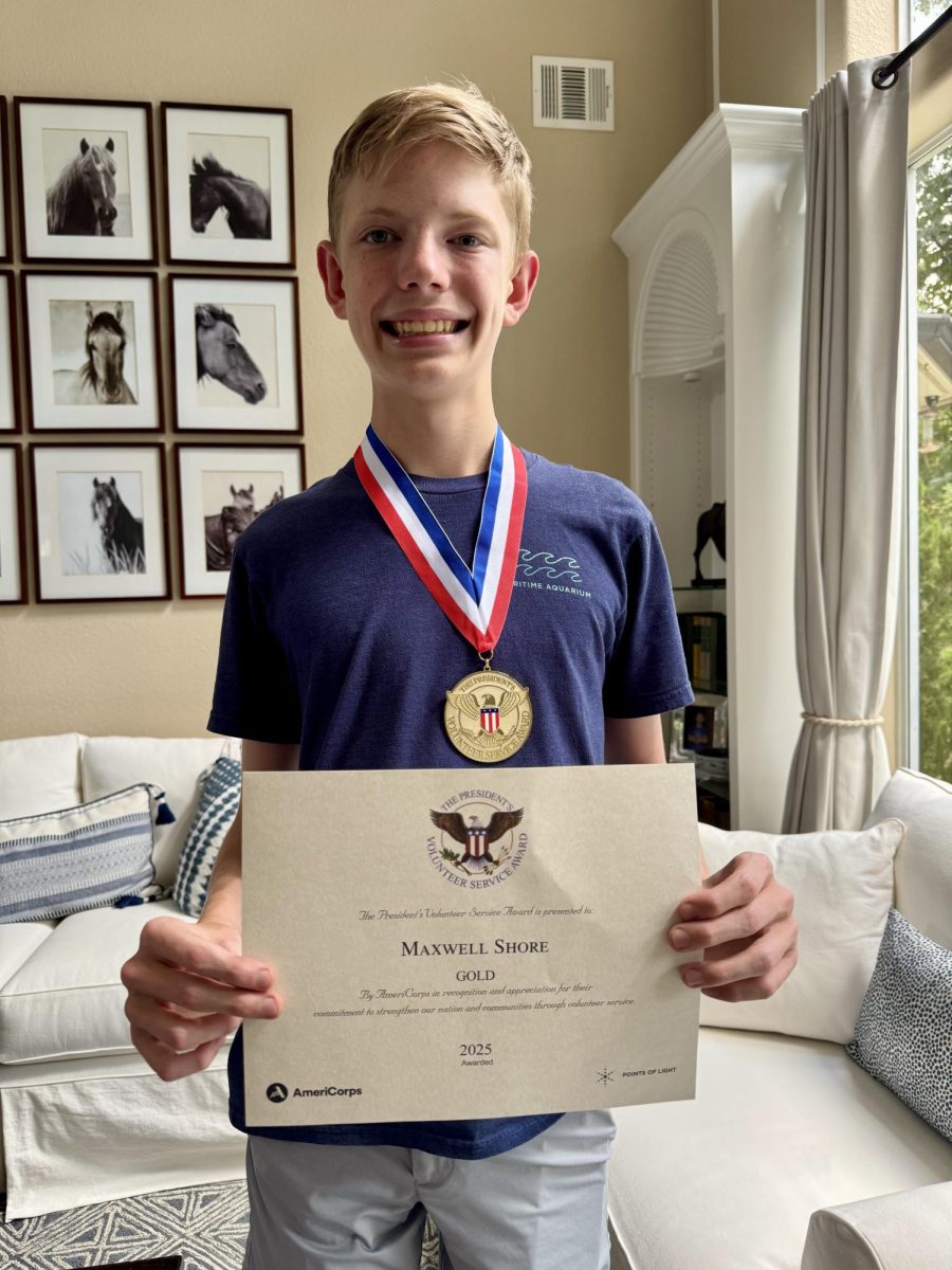 Maxwell Shore showcases his Presidential Volunteer Service Award. 