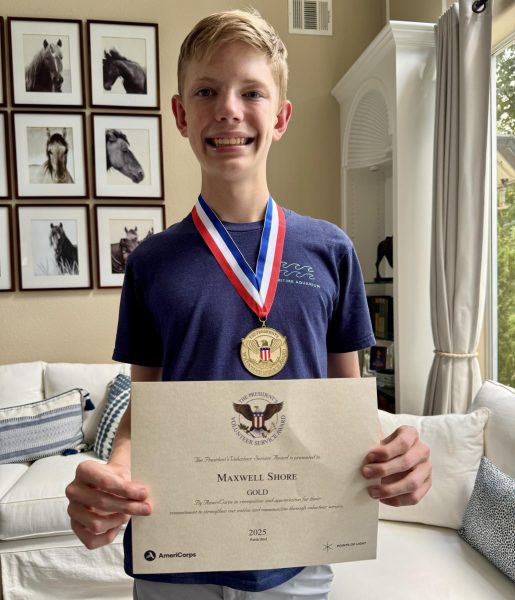 Maxwell Shore showcases his Presidential Volunteer Service Award. 