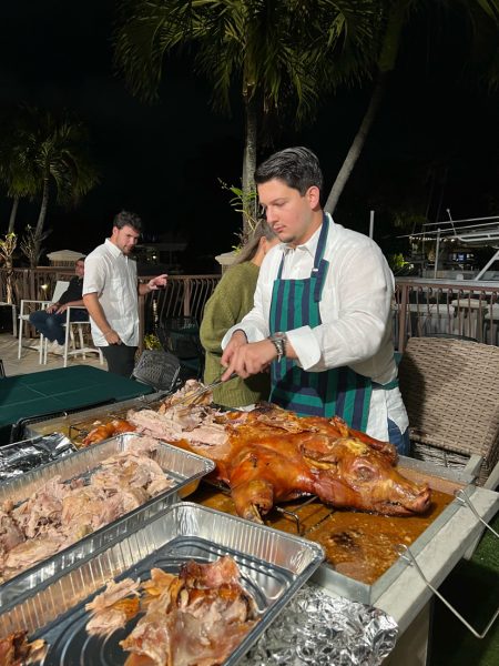 Rey Dorta, Bella Herrara's cousin, cutting pork at Thanksgiving.