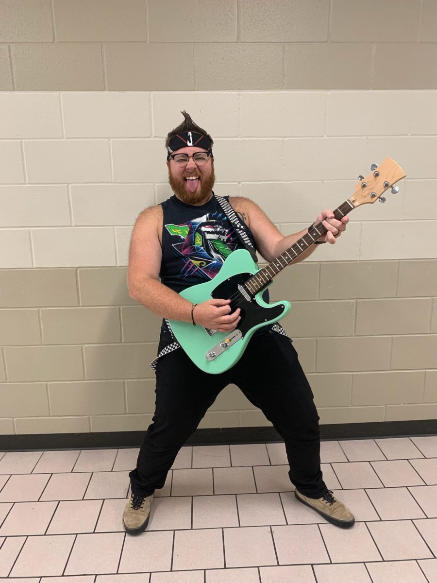 Mr. Rogers jamming out on his turquoise guitar. 