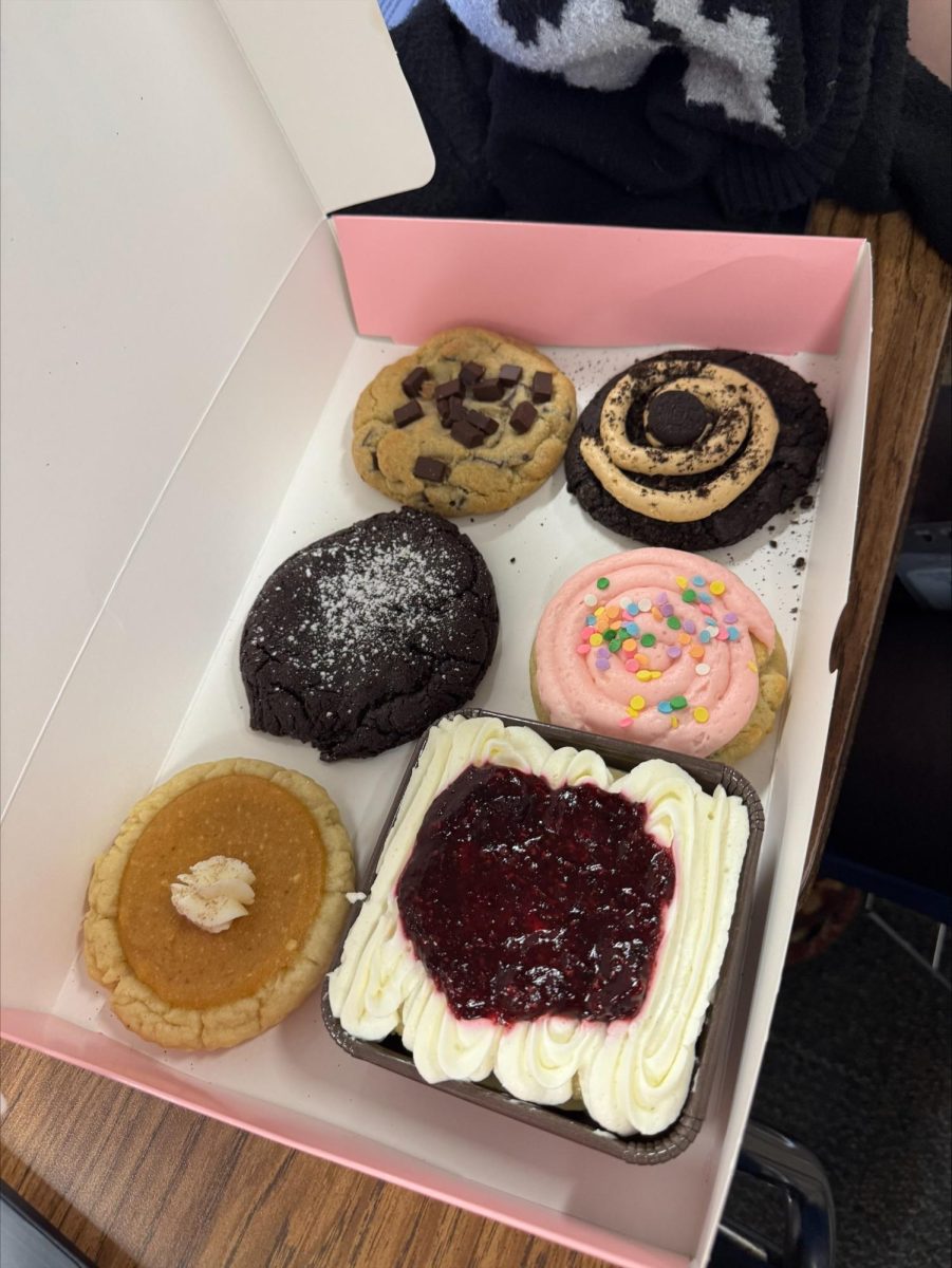 A selection of five Crumbl cookies and a berry shortcake.