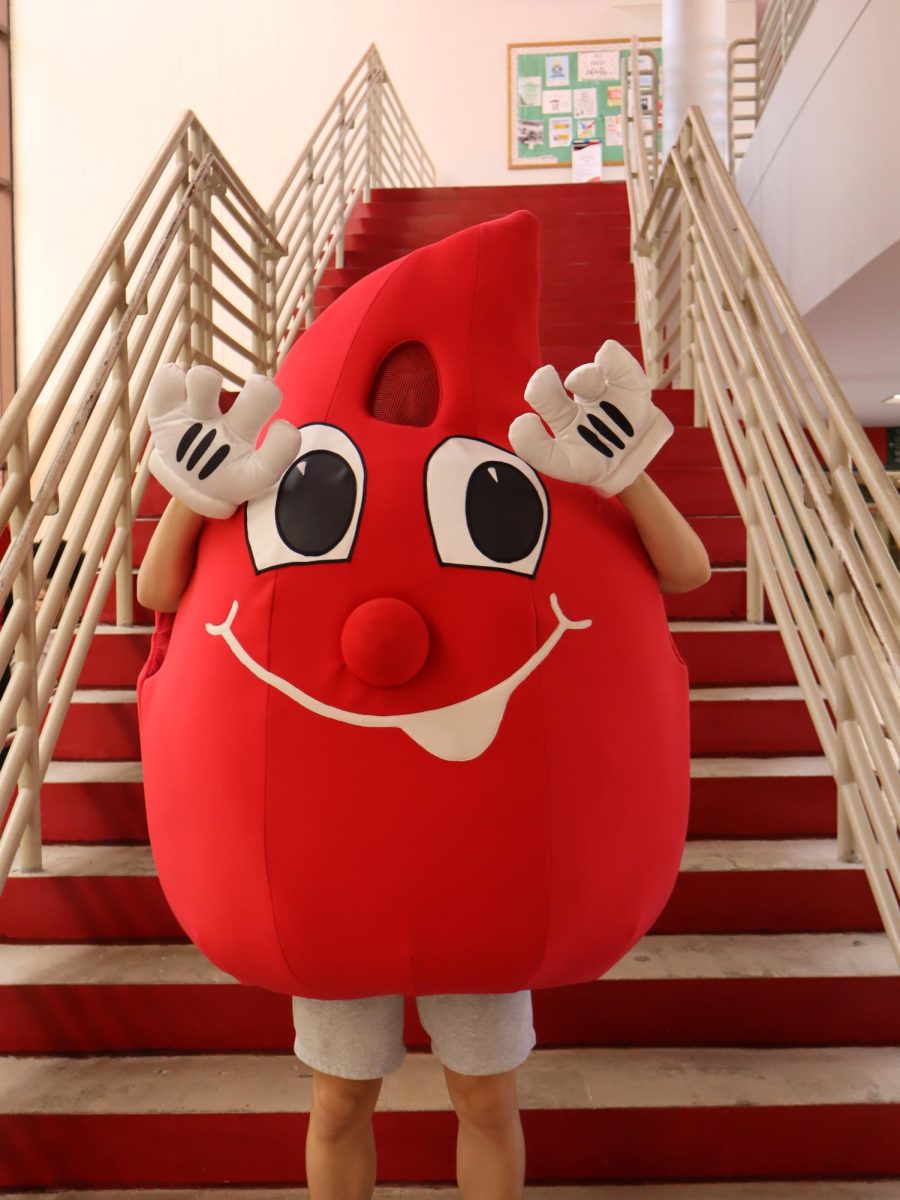 The blood drop student mascot encourages students to sign-up on January 29, in the high school cafeteria. 
