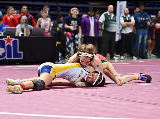 Brynlee Mooney wrestles at Berry Center on February 14, 2026.  With about a minute and thirty seconds left her opponent was held bringing the score from 4-4 to 4–11. Brynlee won the semifinals match by major decision. Photo by Carissa Mooney, used with permission.
