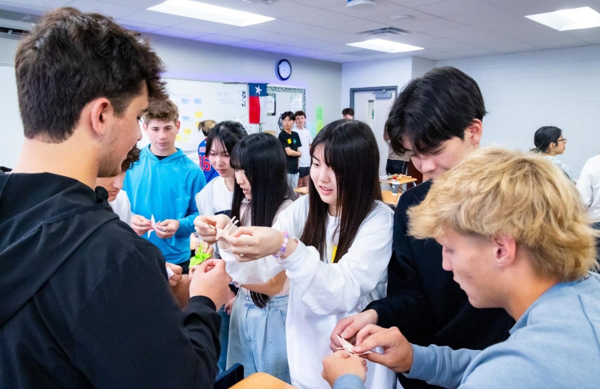 Students from Ritsumeikan High School  in Kyoto, Japan visited classes at TWHS on March 25,2026. The students demonstrated traditional Japanese games, calligraphy, and origami while our students taught them to play Uno, demonstrated American football drills, and suggested their favorite fast food places to visit while they are here! Photo by Dr. Dodie Spencer, used with permission.